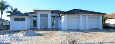 Picture showing the Construction of a home in the rough stage with the rooftiles on and painted outside