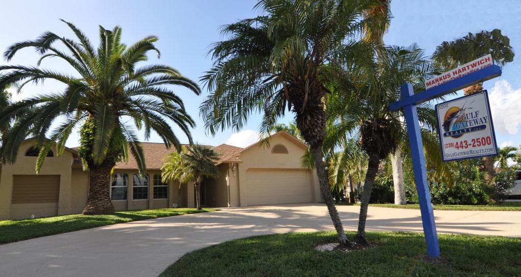Picture of a listed home in Cape Coral with a for sale sign in the front yard