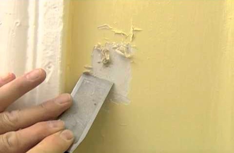 Picture of scraping Lead based paint off a wall during an inspection