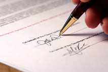 Picture of a real estate contract being signed